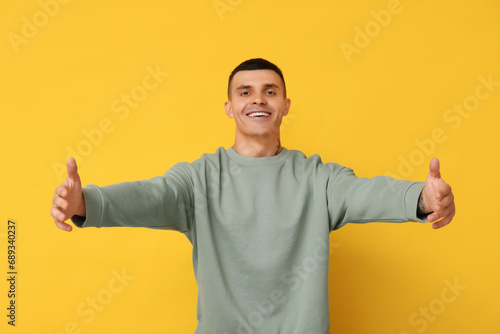 Handsome young man opening ...