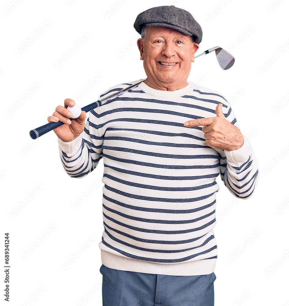 Senior handsome grey-haired man holding golf club and ball pointing finger to one self smiling happy and proud