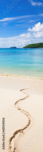 A sandy beach with footprints in the sand, vertical panoramic banner. © Friedbert