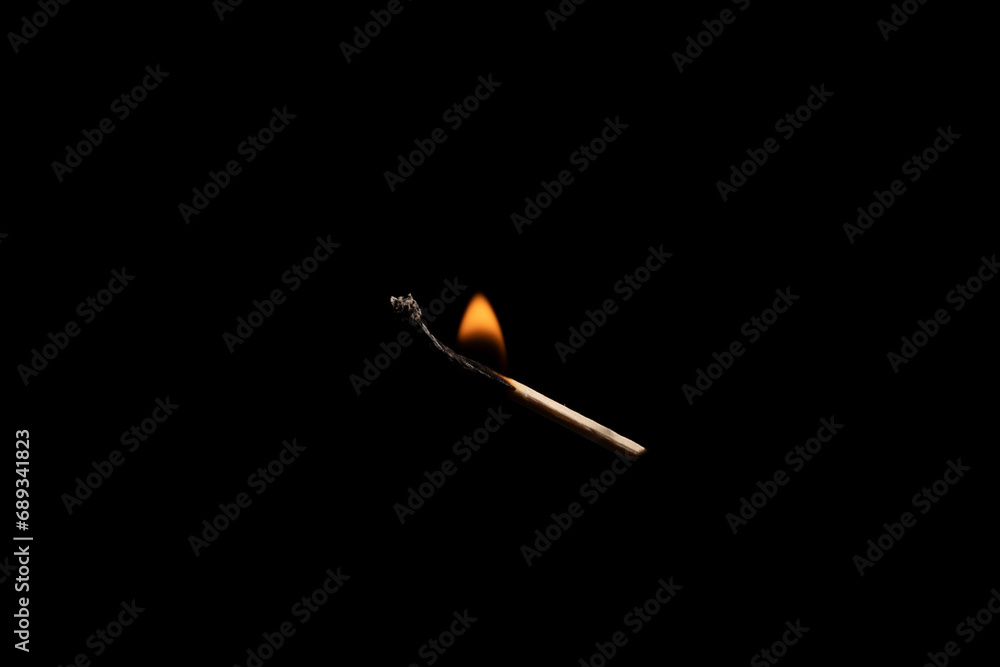 Lit falling match on a black background. Lit falling match on a black background.