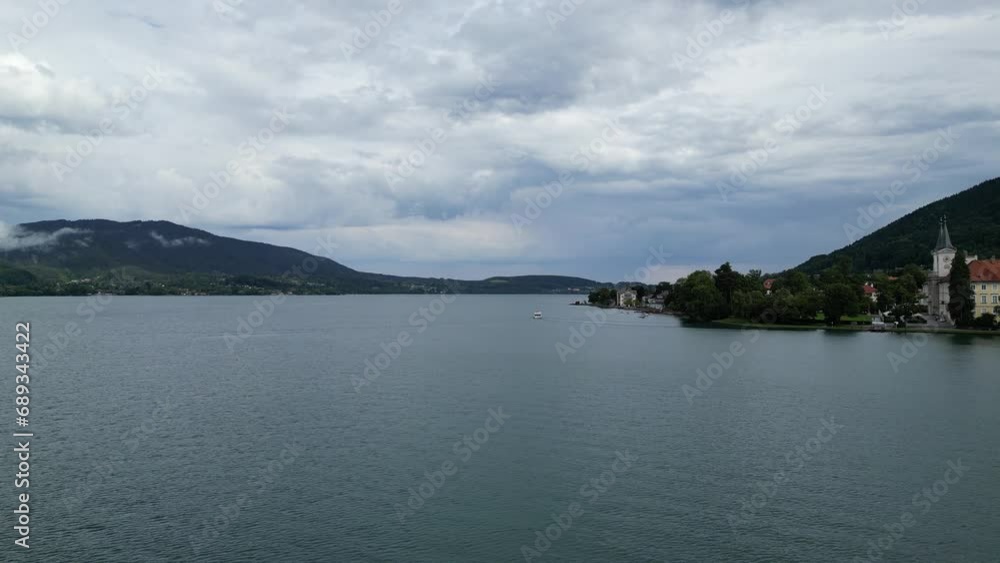 Flight with rise over lake Tegernsee following a ferry and mountain panorama in Bavaria, Germany Flight with rise over lake Tegernsee following a ferry and mountain panorama in Bavaria, Germany