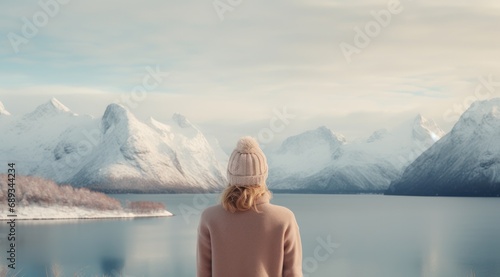 a woman looking towards the mountains and lake,