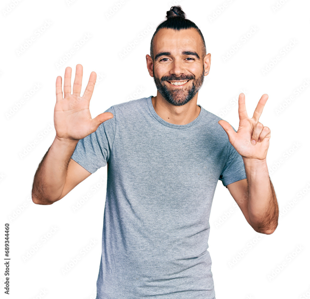 Hispanic man with ponytail wearing casual grey t shirt showing and pointing up with fingers number eight while smiling confident and happy. Hispanic man with ponytail wearing casual grey t shirt showing and pointing up with fingers number eight while smiling confident and happy.