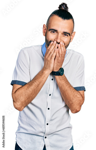 Obraz na płótnie Hispanic man with ponytail wearing casual white shirt laughing and embarrassed g