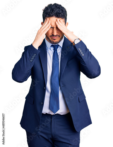 Obraz na plátně Young hispanic man wearing business clothes suffering from headache desperate and stressed because pain and migraine