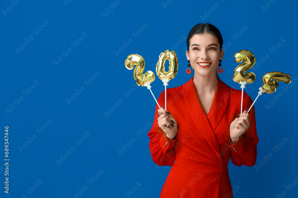 Beautiful young happy woman with figure 2024 made of balloons on blue background. Chinese New Year celebration Beautiful young happy woman with figure 2024 made of balloons on blue background. Chinese New Year celebration