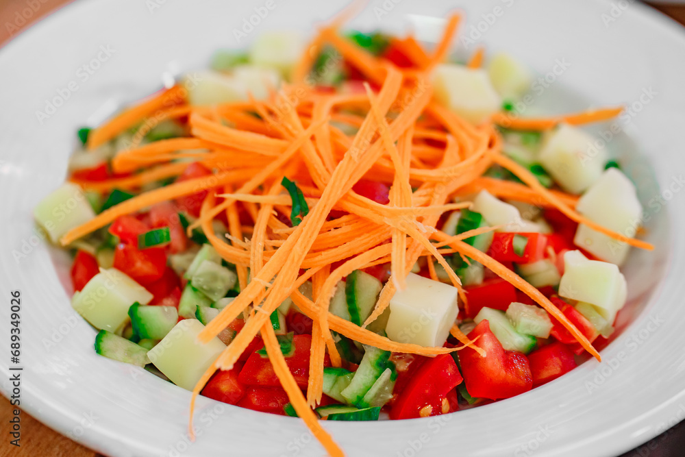 vegetable salad of carrots, cucumbers and tomatoes, close-up, selective focus vegetable salad of carrots, cucumbers and tomatoes, close-up, selective focus
