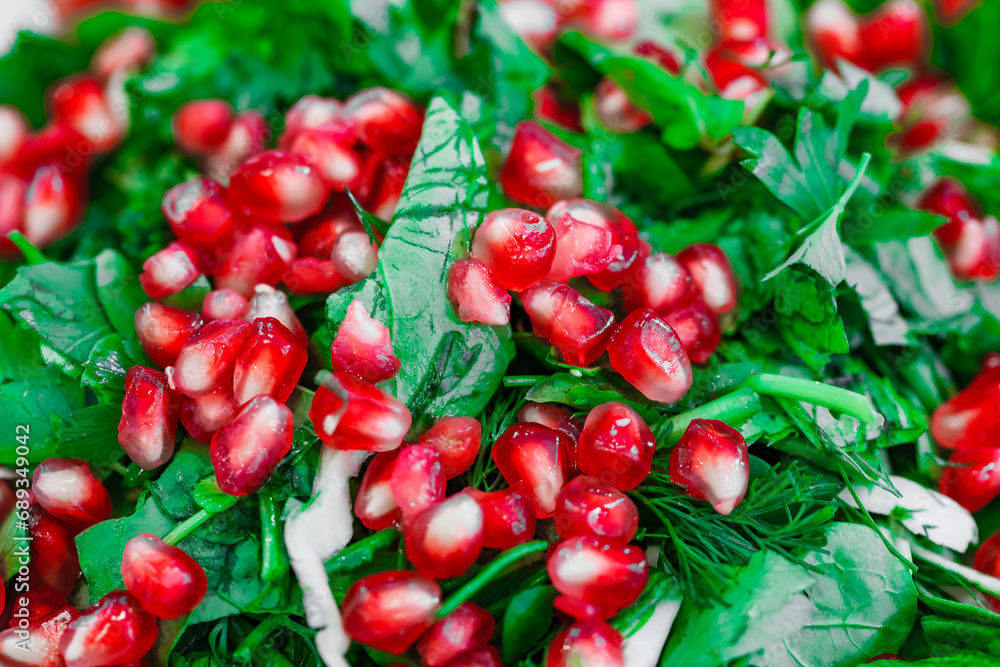 vegetarian salad of greens and pomegranate seeds, close-up, selective focus vegetarian salad of greens and pomegranate seeds, close-up, selective focus
