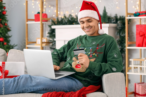 Young happy man with credit...