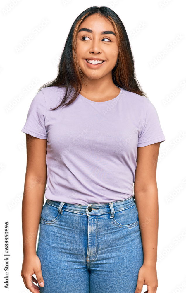 Young latin woman wearing casual clothes smiling looking to the side and staring away thinking. Young latin woman wearing casual clothes smiling looking to the side and staring away thinking.