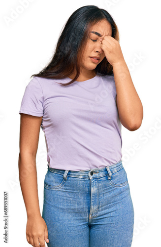 Young latin woman wearing casual clothes tired rubbing nose and eyes feeling fatigue and headache. stress and frustration concept.