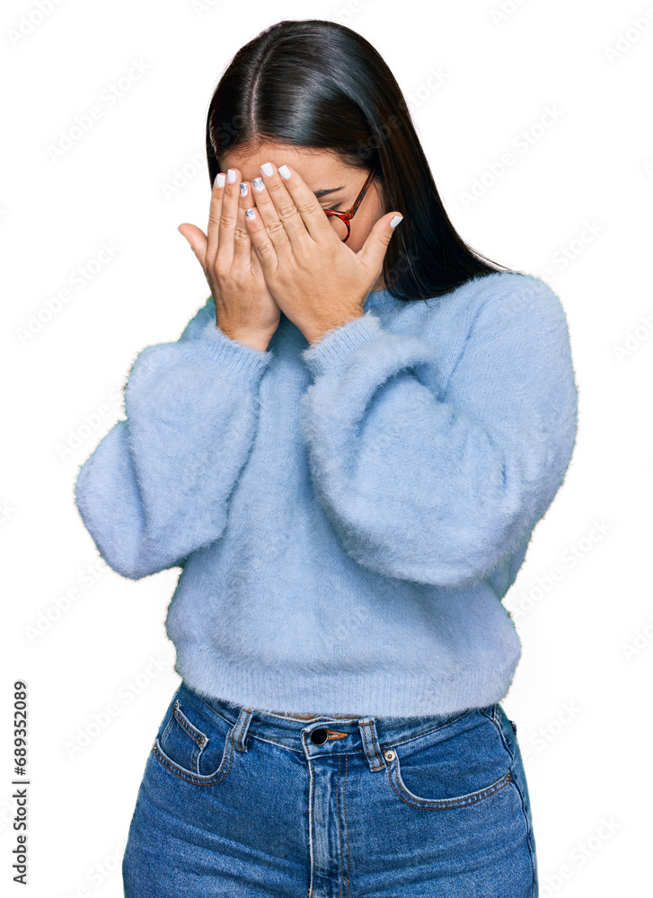 Young hispanic woman wearing casual clothes and glasses with sad expression covering face with hands while crying. depression concept. Young hispanic woman wearing casual clothes and glasses with sad expression covering face with hands while crying. depression concept.