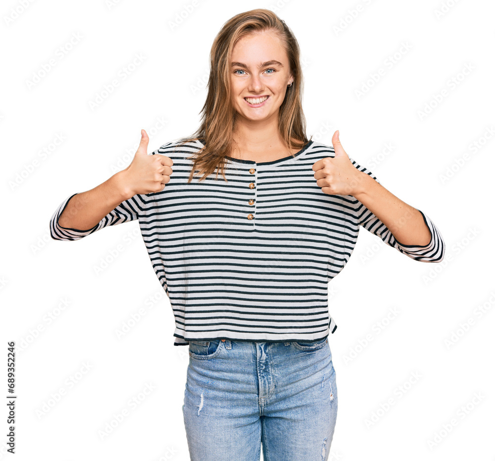 Obraz premium Beautiful blonde woman wearing casual clothes success sign doing positive gesture with hand, thumbs up smiling and happy. cheerful expression and winner gesture.