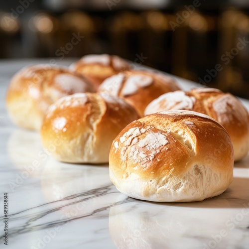Delicious bread rolls on a marble counter top.