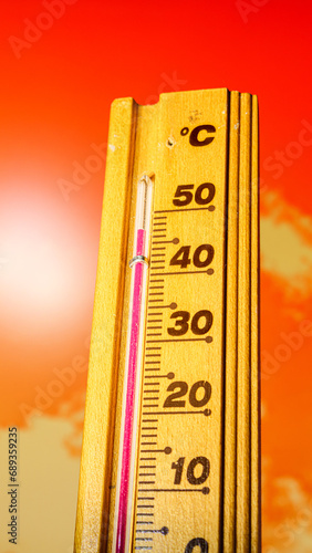 The thermometer displays a high heatwave temperature of 47 degrees Celsius. A red alarm gives a warning of the extreme weather conditions caused by global climate change on Earth. Hot summer season.