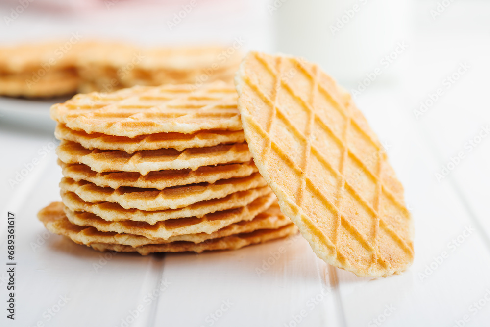 Round waffle biscuits on white table. Round waffle biscuits on white table.