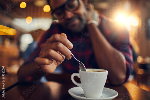 Man Enjoying a Fresh Cup of Coffee in Cafe photo