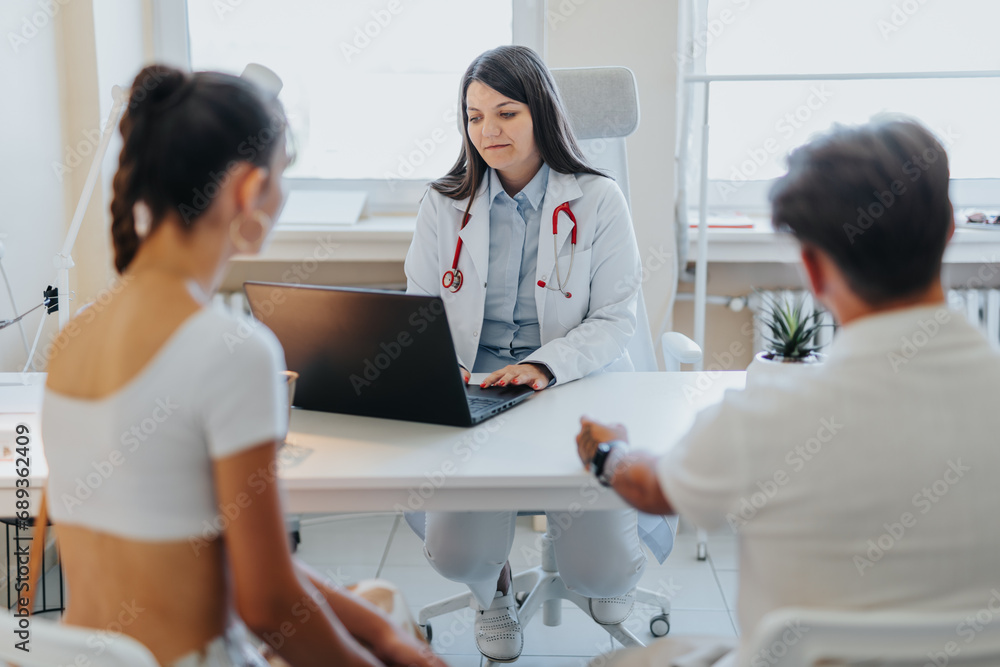 Successful Doctors Discussing Medical Results with a Couple in Clinic Successful Doctors Discussing Medical Results with a Couple in Clinic