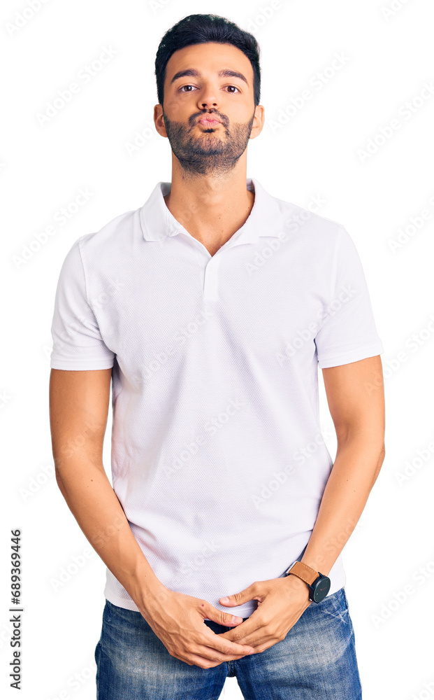 Young handsome hispanic man wearing casual clothes looking at the camera blowing a kiss on air being lovely and sexy. love expression. Young handsome hispanic man wearing casual clothes looking at the camera blowing a kiss on air being lovely and sexy. love expression.