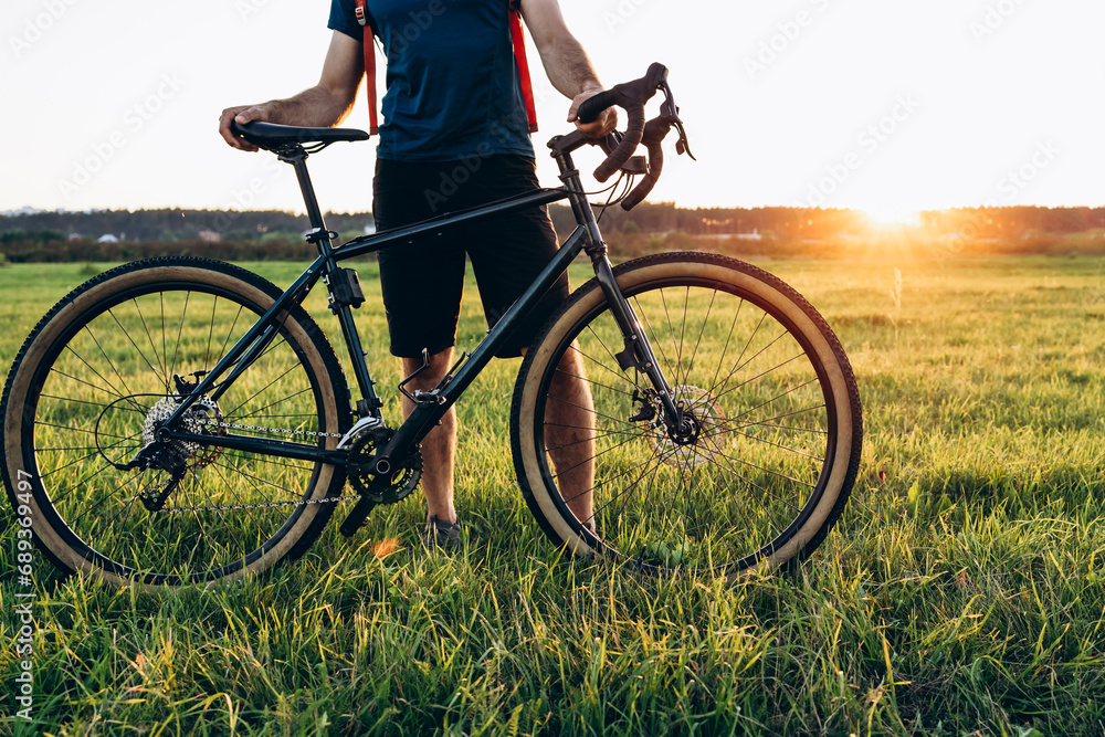 Mountain biker cycling a bike during ar sunset outside. Healthy lifestyle and outdoor adventure concept Mountain biker cycling a bike during ar sunset outside. Healthy lifestyle and outdoor adventure concept
