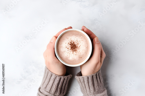 Hand hold cup of hot chocolate cocoa drink on white background. Top view. Generated AI photo