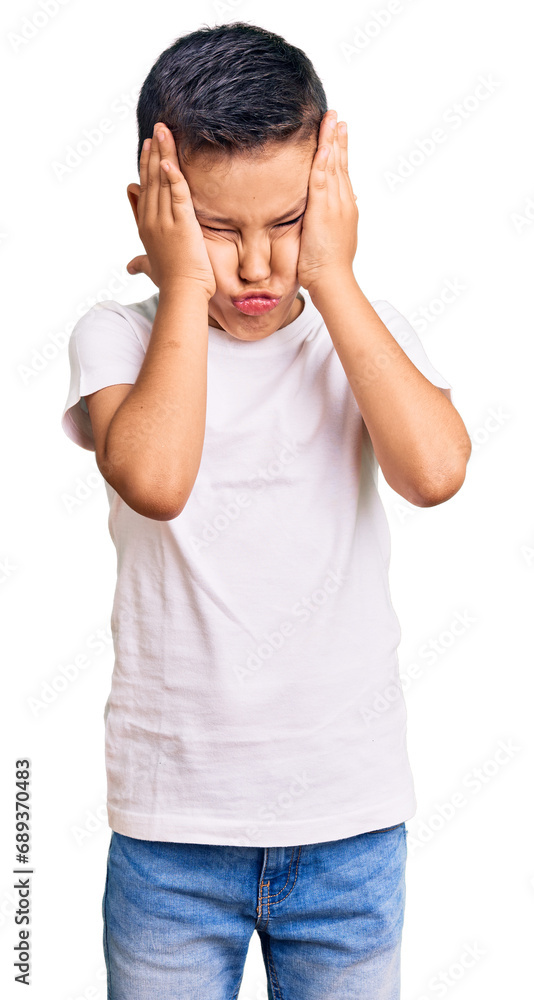 Little cute boy kid wearing casual white tshirt suffering from headache desperate and stressed because pain and migraine. hands on head. Little cute boy kid wearing casual white tshirt suffering from headache desperate and stressed because pain and migraine. hands on head.