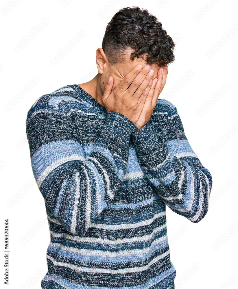 Hispanic young man wearing casual clothes with sad expression covering face with hands while crying. depression concept. Hispanic young man wearing casual clothes with sad expression covering face with hands while crying. depression concept.