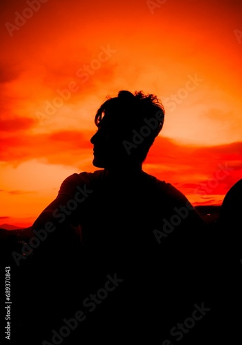 the silhouette of a man with his arm in the air