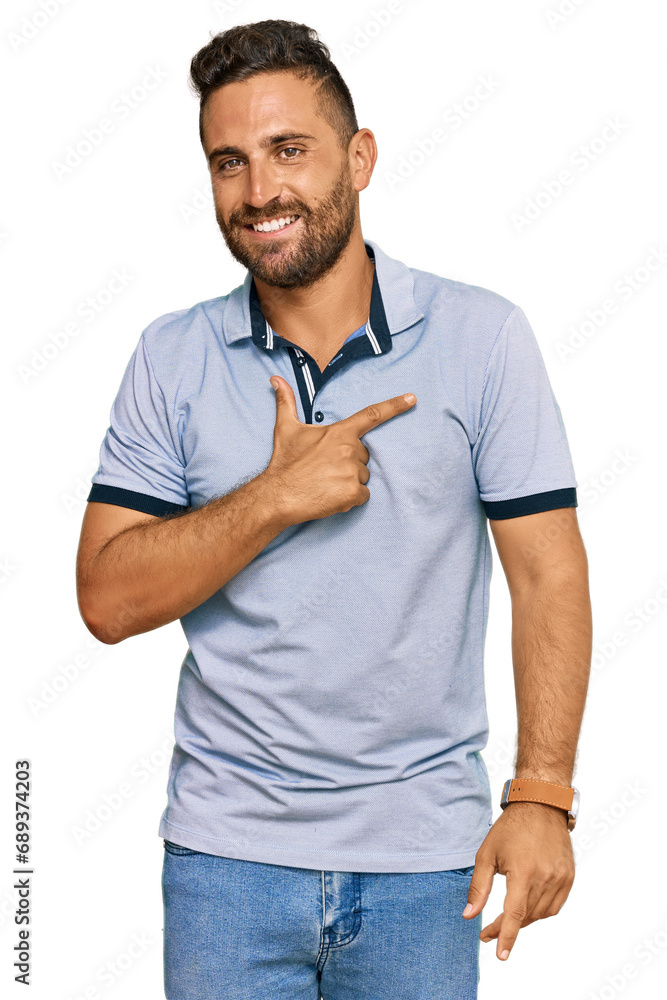 Handsome man with beard wearing casual clothes cheerful with a smile on face pointing with hand and finger up to the side with happy and natural expression Handsome man with beard wearing casual clothes cheerful with a smile on face pointing with hand and finger up to the side with happy and natural expression