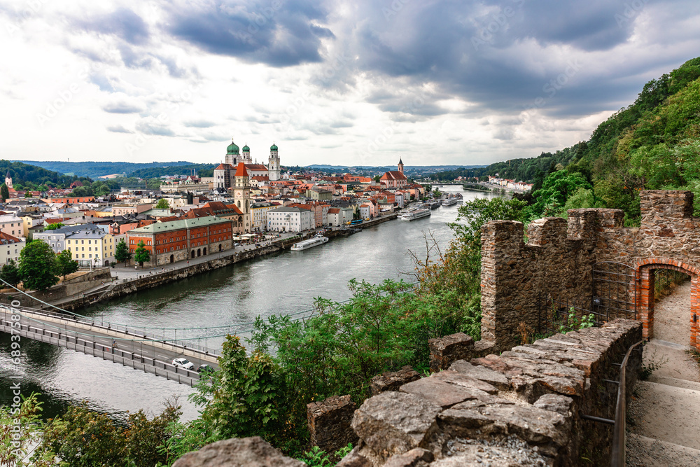 Panoramic view of Passau. Top view of suspension bridge. Aerial skyline of old town with beautiful reflection in Danube river, Bavaria, Germany. High quality photo