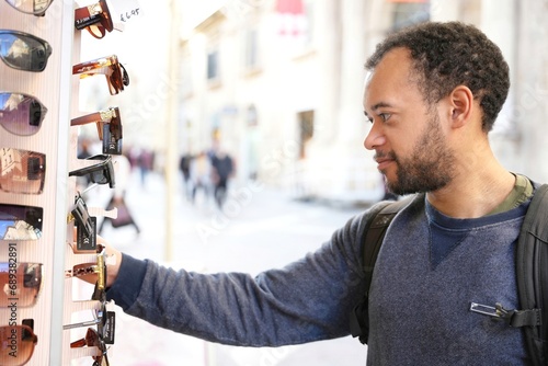 Man looking to buy sunglasses at street store
