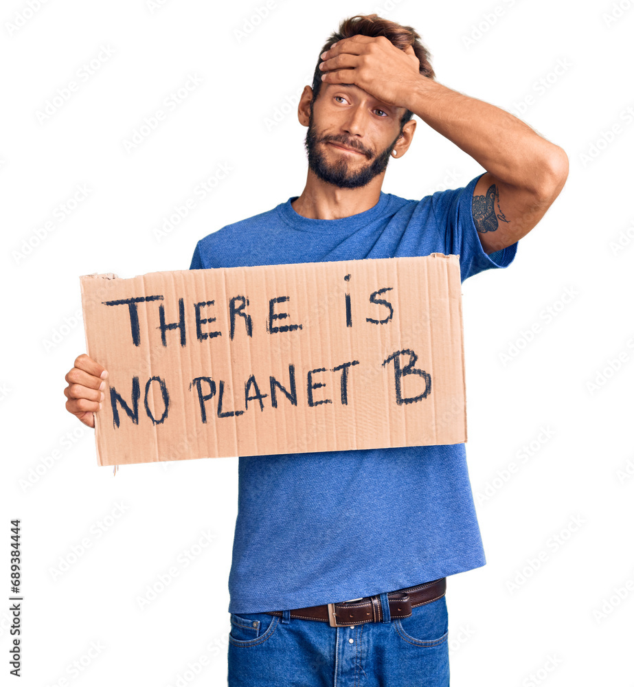 Handsome blond man with beard holding there is no planet b banner stressed and frustrated with hand on head, surprised and angry face Handsome blond man with beard holding there is no planet b banner stressed and frustrated with hand on head, surprised and angry face