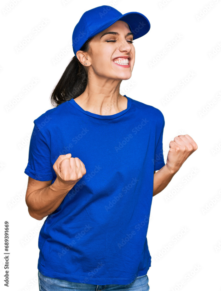 Young hispanic girl wearing delivery courier uniform excited for success with arms raised and eyes closed celebrating victory smiling. winner concept.