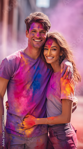 Young couple having fun at Holi party.