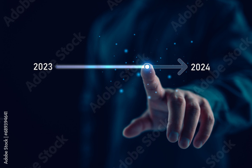 Businessman touch on virtual bar status to change from 2023 to 2024, countdown of merry Christmas and happy new year by technology concept, start new business and new life. New year's start-up.