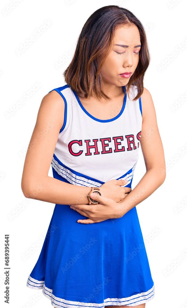 Young beautiful chinese girl wearing cheerleader uniform with hand on stomach because indigestion, painful illness feeling unwell. ache concept. Young beautiful chinese girl wearing cheerleader uniform with hand on stomach because indigestion, painful illness feeling unwell. ache concept.