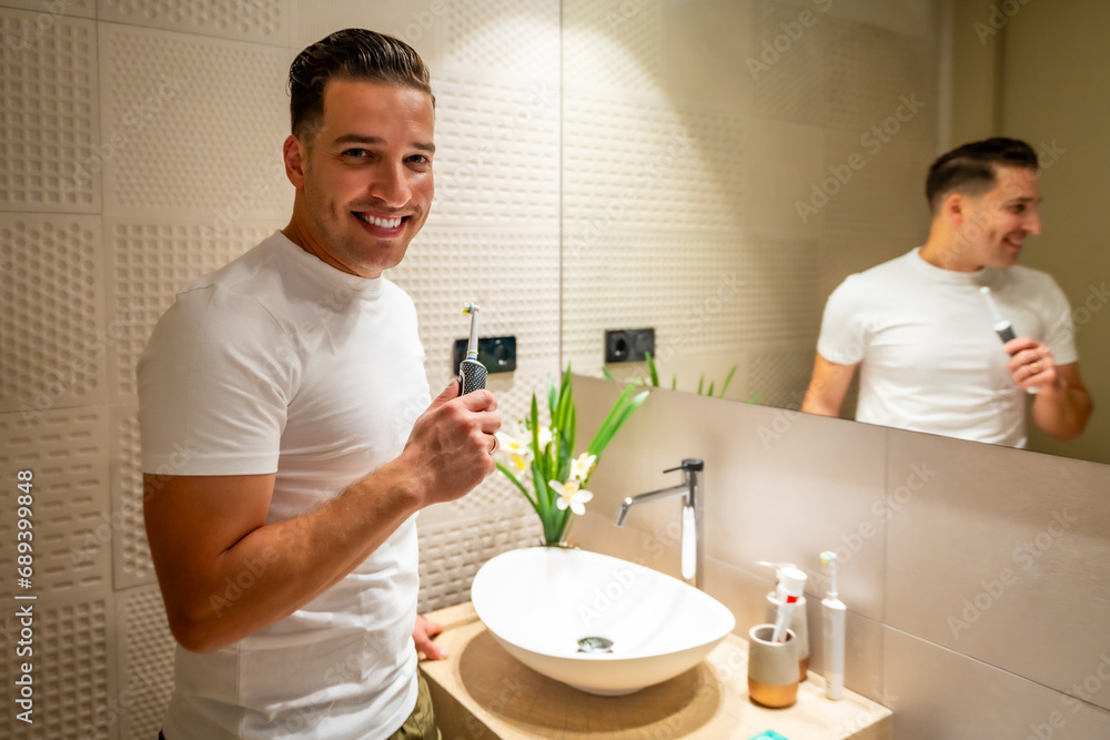 Man smiling after cleaning his teeth in the bathroom Man smiling after cleaning his teeth in the bathroom