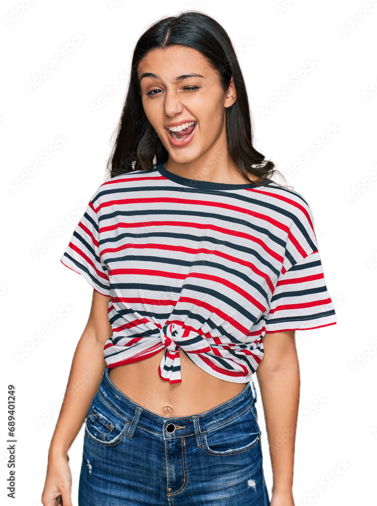 Fototapeta premium Young hispanic girl wearing casual clothes winking looking at the camera with sexy expression, cheerful and happy face.