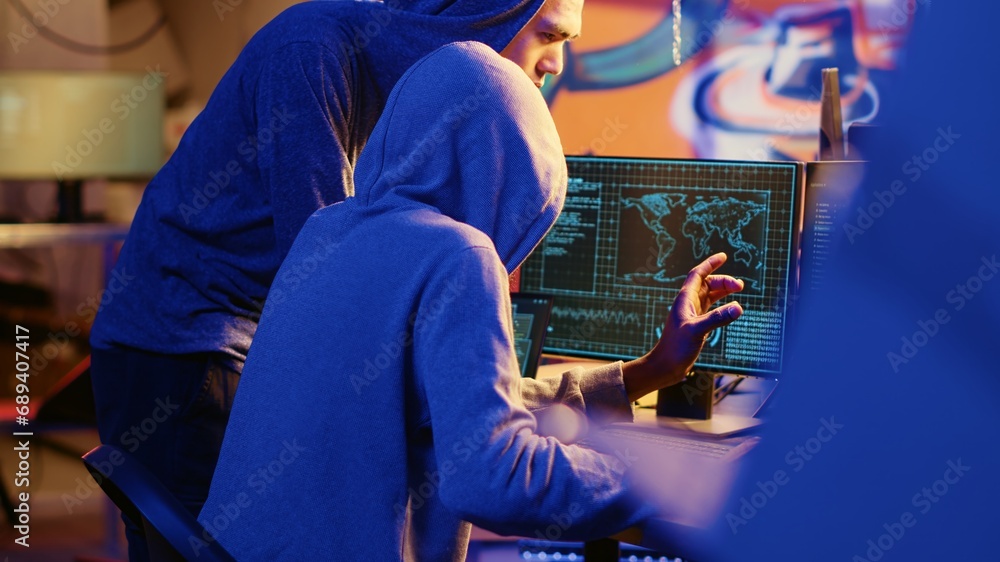 Hacking group founder initiating new member, showing him how to destroy