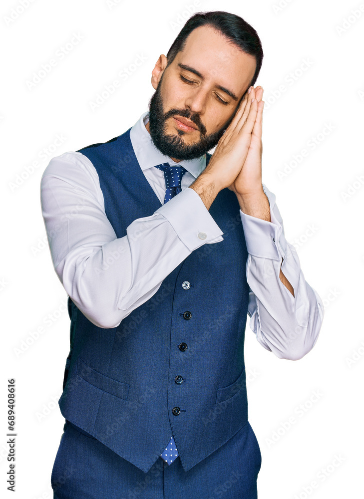 Young man with beard wearing business vest sleeping tired dreaming and posing with hands together while smiling with closed eyes. Young man with beard wearing business vest sleeping tired dreaming and posing with hands together while smiling with closed eyes.