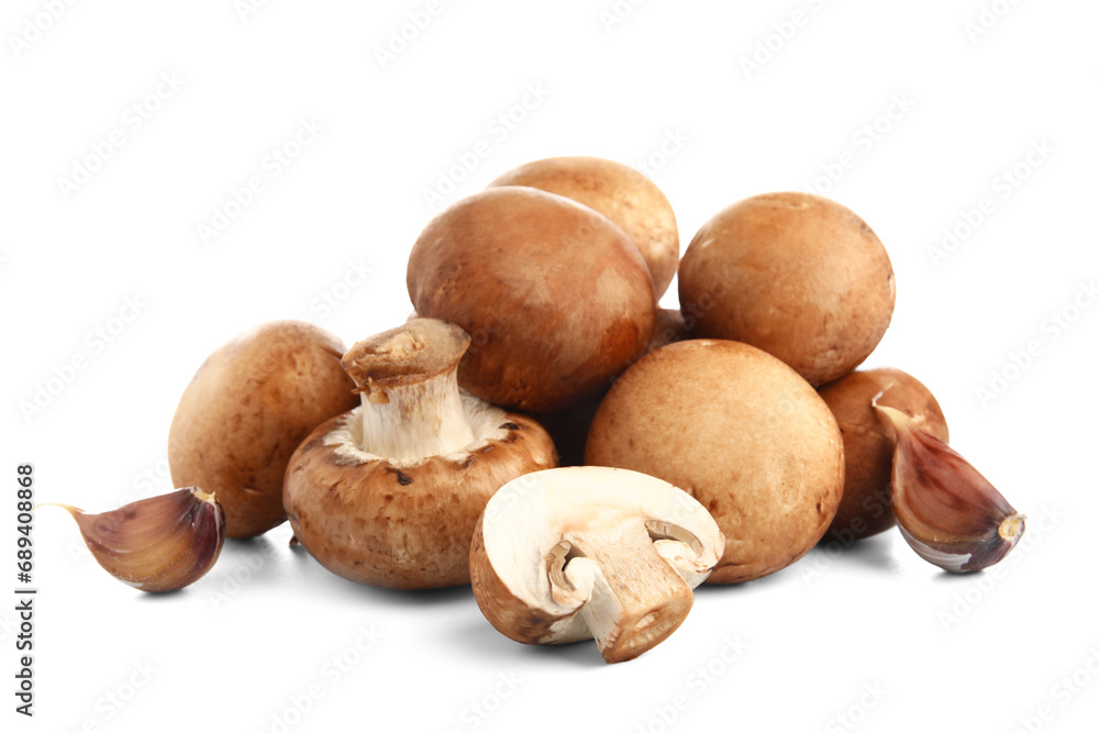 Set of raw champignon mushrooms with garlic on white background