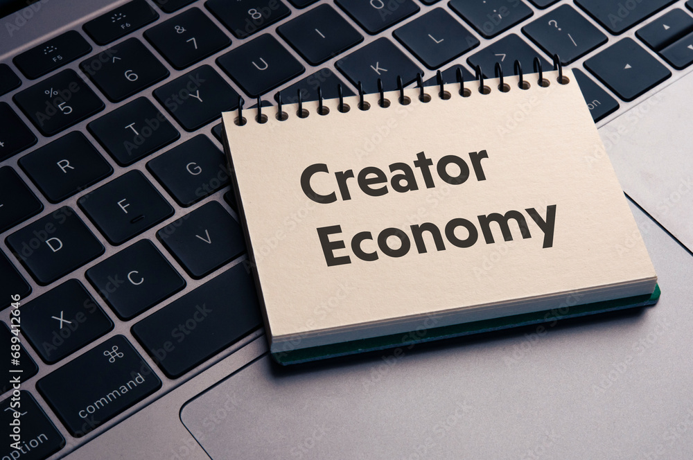 There is notebook with the word Creator Economy. It is as an eye-catching image.