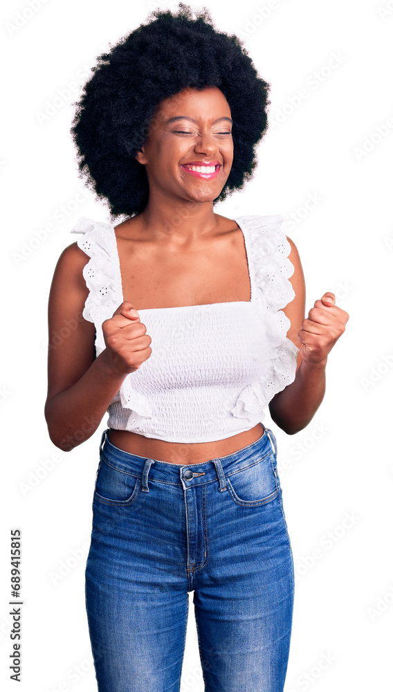 Young african american woman wearing casual clothes excited for success with arms raised and eyes closed celebrating victory smiling. winner concept. Young african american woman wearing casual clothes excited for success with arms raised and eyes closed celebrating victory smiling. winner concept.
