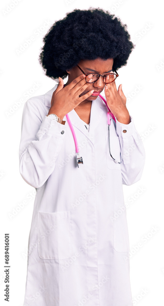 Young african american woman wearing doctor coat and stethoscope rubbing eyes for fatigue and headache, sleepy and tired expression. vision problem