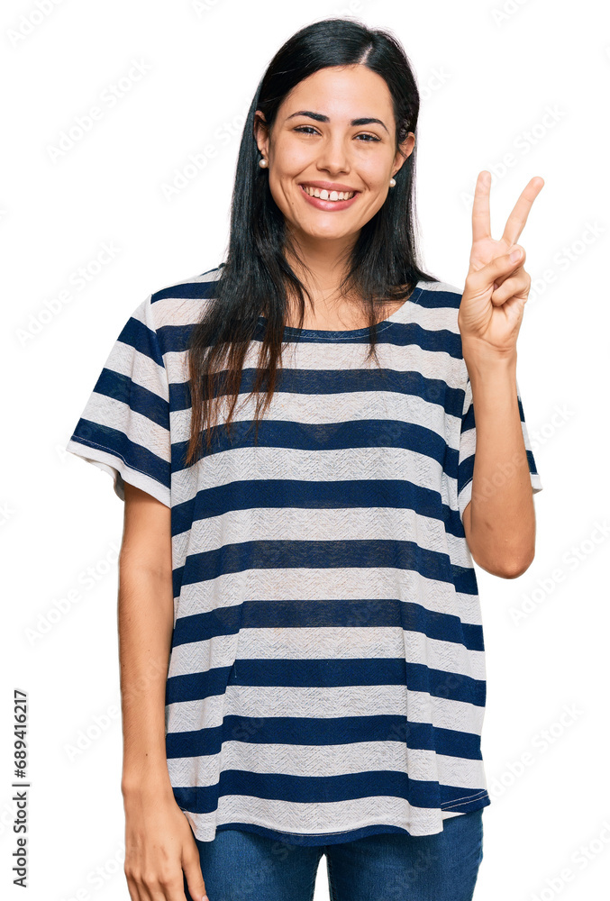 Beautiful young woman wearing casual clothes showing and pointing up with fingers number two while smiling confident and happy. Beautiful young woman wearing casual clothes showing and pointing up with fingers number two while smiling confident and happy.