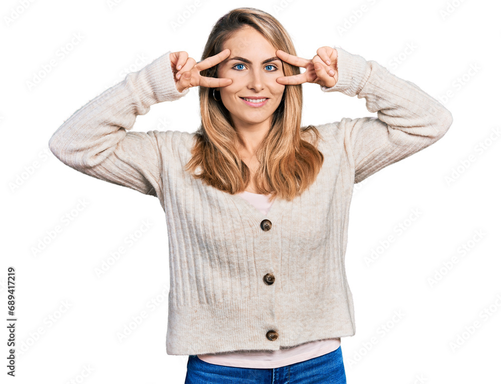 Young blonde woman wearing casual clothes doing peace symbol with fingers over face, smiling cheerful showing victory Young blonde woman wearing casual clothes doing peace symbol with fingers over face, smiling cheerful showing victory