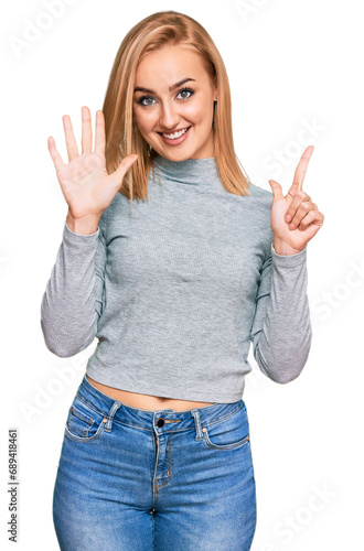 Beautiful caucasian woman wearing casual clothes showing and pointing up with fingers number seven while smiling confident and happy.