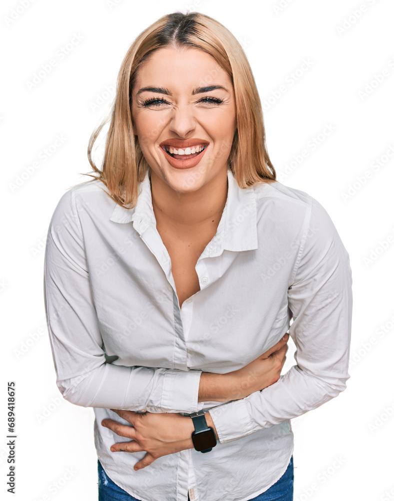 Young caucasian woman wearing casual clothes smiling and laughing hard out loud because funny crazy joke with hands on body. Young caucasian woman wearing casual clothes smiling and laughing hard out loud because funny crazy joke with hands on body.