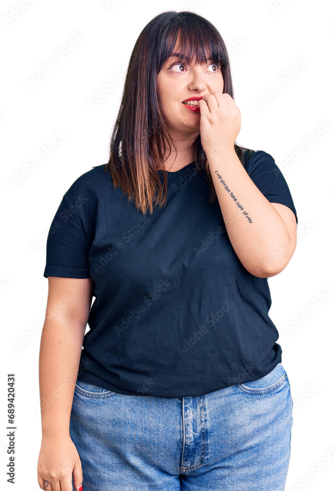 Young plus size woman wearing casual clothes looking stressed and nervous with hands on mouth biting nails. anxiety problem. Young plus size woman wearing casual clothes looking stressed and nervous with hands on mouth biting nails. anxiety problem.