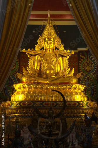 Phra Buddha Hiranrat His body was dressed in royal garb in the pose of bestowing blessings as the principal Buddha image. At Sacred Hall in Wat Tha Mai temple. Located at Samut Sakhon in Thaiiand.